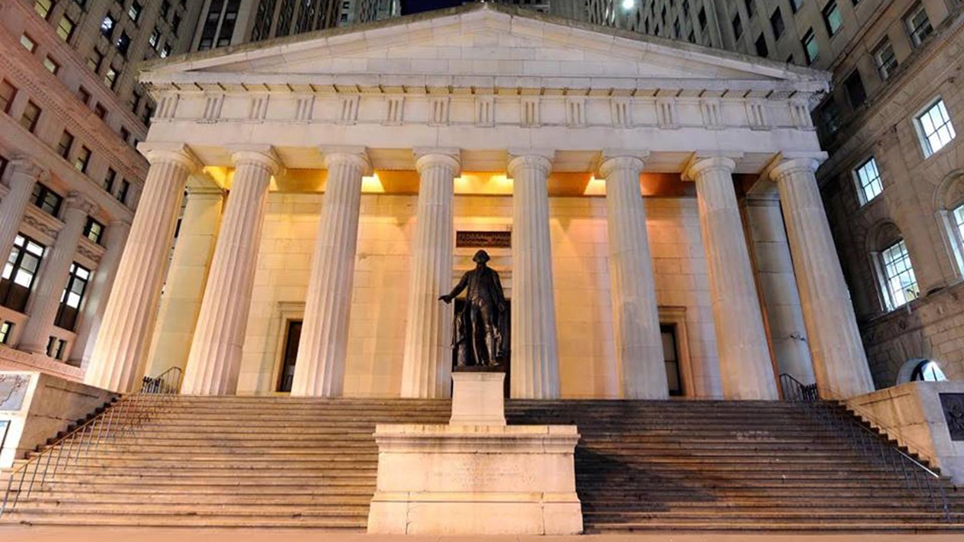 Statue of George Washington in front of a classical-style building