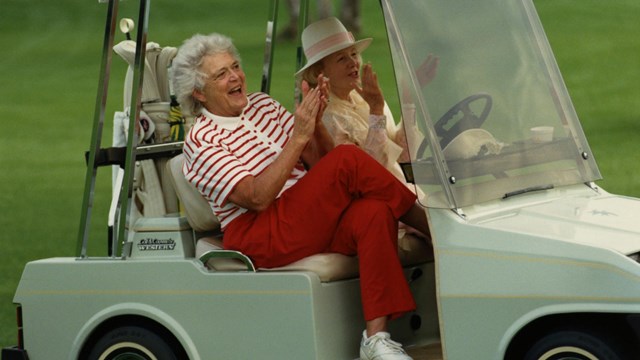 Barbara Bush in a golf cart.