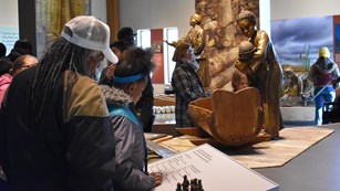 Visitors reading exhibit panels
