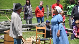 Performers reenacting history with spectators in the back