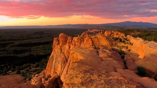 Sunset over a rock bluff in the desert