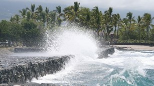 ocean waves hitting a line of rocks 