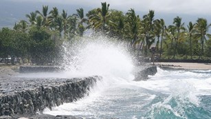 ocean waves hitting a line of rocks