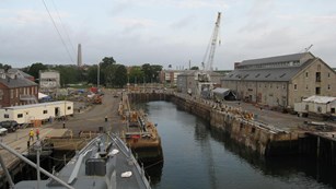 Bow of a WWII ship pulled into a navy yard