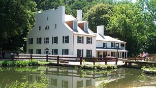 White tavern building next to a canal