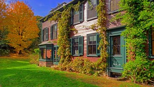 Two-story brick house covered with vines