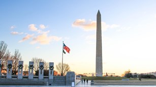 Flag over a World War II with Washington Monument in the background