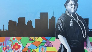 Mural of Maggie Walker in front of a Richmond skyline