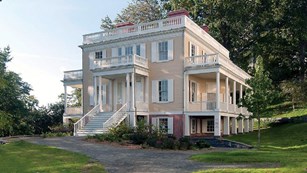 Two-story light yellow historic home