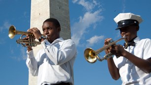 Trumpeters with monument in the background
