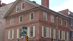 Corner view of large, red brick, colonial building