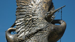 Metal statue of a crane