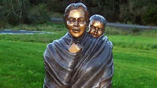Statue of Sacagawea carrying a baby on her back