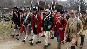 Living historians interpreting minute men marching