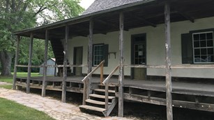 Historic one-story house with a prominent porch