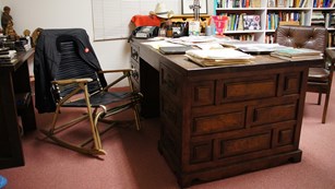 Office room with a desk covered in papers