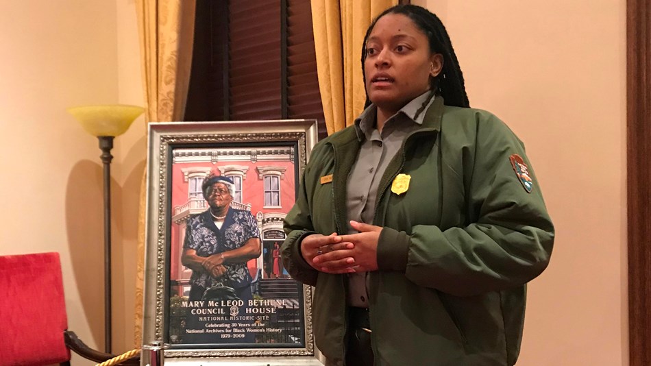 Ranger talking next to a painting of Mary McLeod Bethune