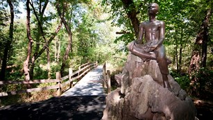bronze statue of man at a park