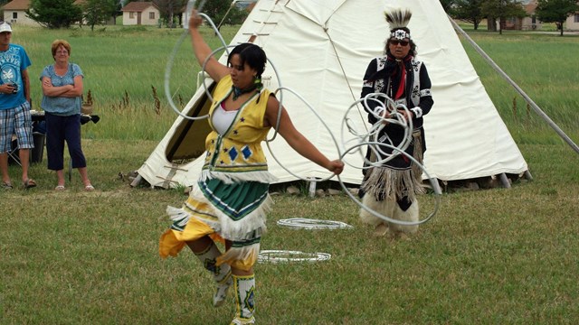 Sioux dancer holding hoops