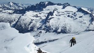 Hiker walking up a snow-covered mountain