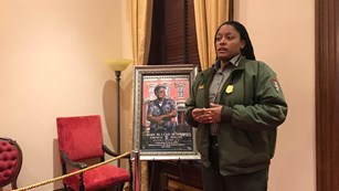 park ranger in front of a picture of Mary McLeod Bethune