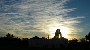 Sillouette of Mission San Juan at sunset.