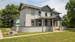 Two-story white house on a big lawn
