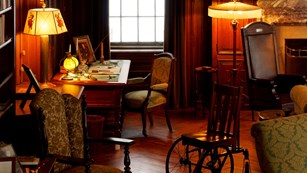 Desk, chair, and wheel chair in a historic home