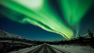 Northern lights over a roadway
