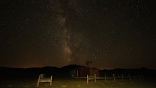 Milky Way over a fence and ranch