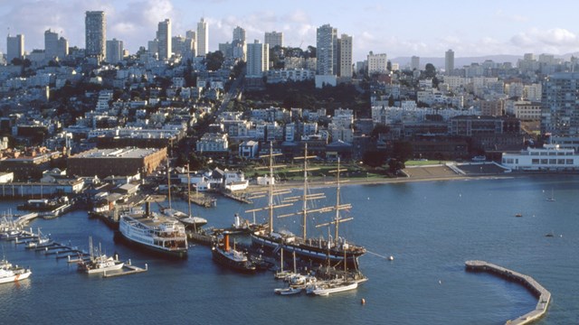 Harbor with historic vessels against the San Francisco skyline