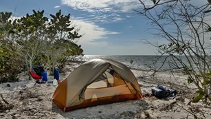 Camping tent set up on an ocean beach