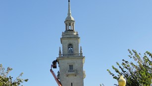 Crane and scaffolding around a stone tower