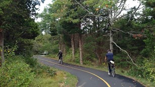 Two bicyclists on a paved trail
