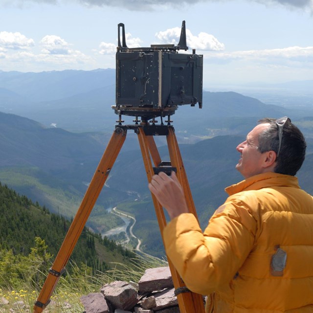 A staff member works to retake historic photographs