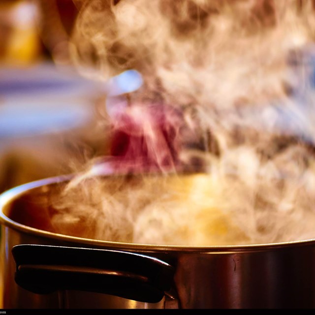 large pot on the stove with steam coming off the top