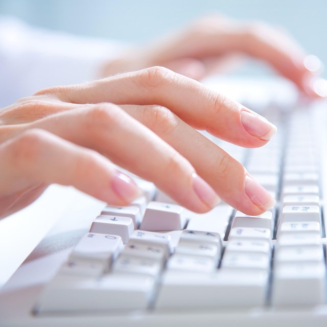 fingers typing on a computer keyboard