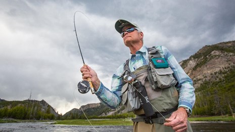 a man with a fly fishing pole