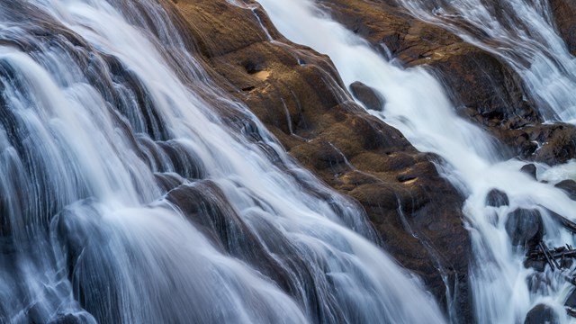 water streams down a small waterfall