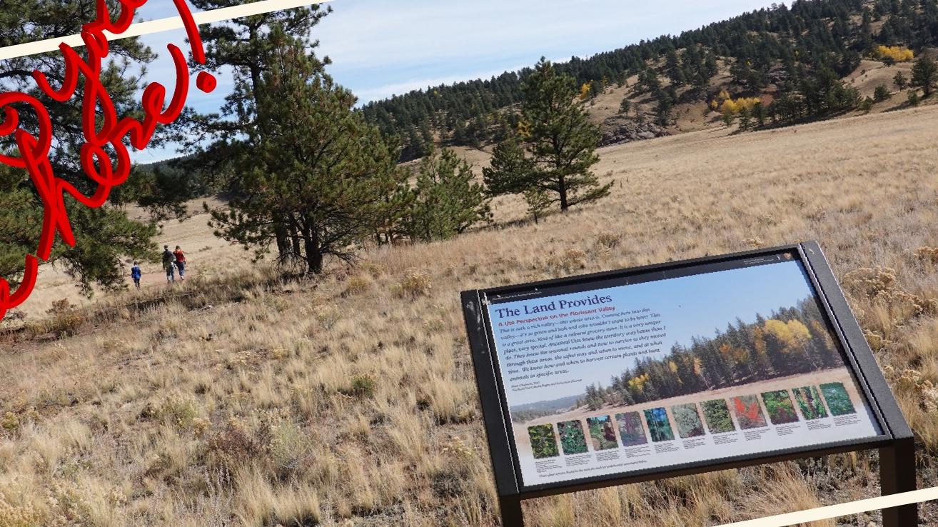 Photograph of grassy valley view and wayside in lower right corner.