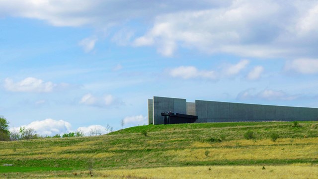 The Visitor Center sits atop of a green grass covered hill.