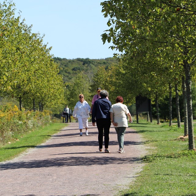 Visitors walking on a trail.