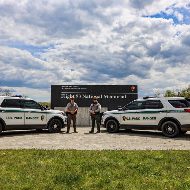Flight 93 National Memorial law enforcements posing in front of the memorial entrance sign.