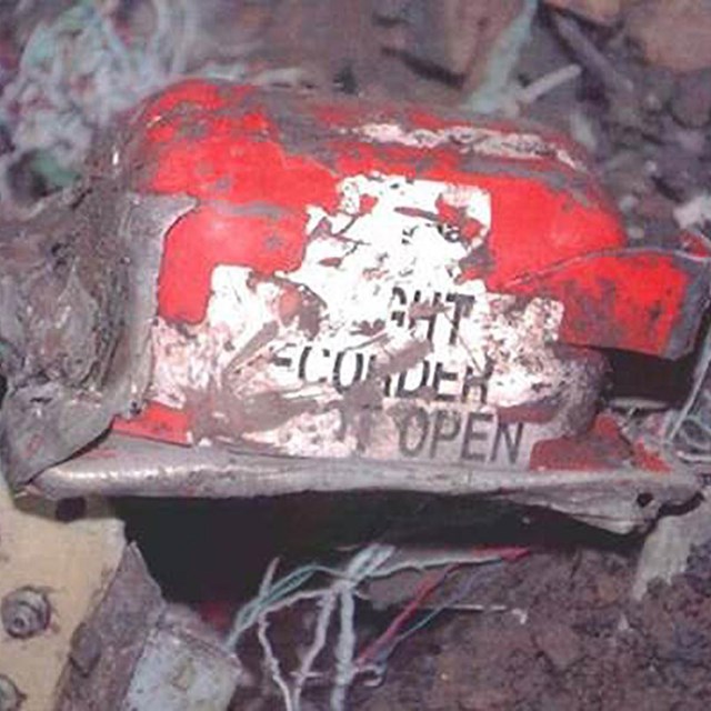The recovered cockpit voice recorder from Flight 93 pictured at the crash site