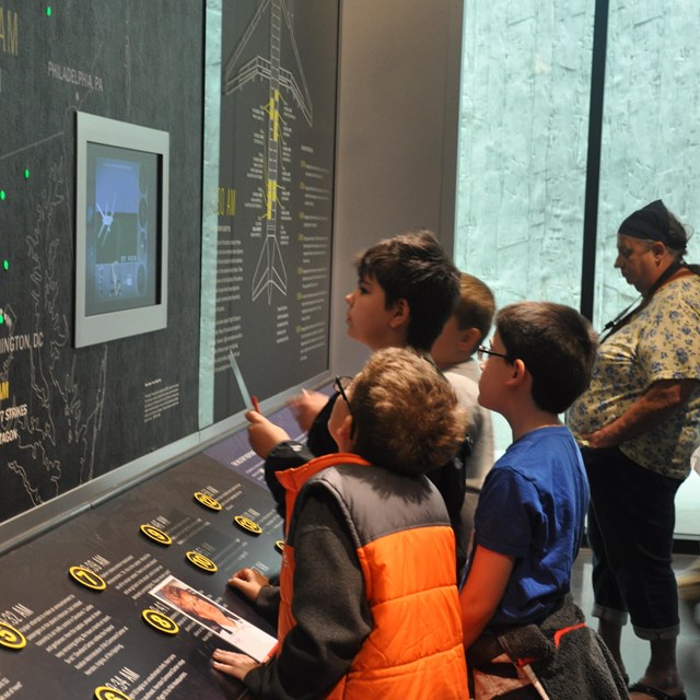 Students standing in front of exhibit.