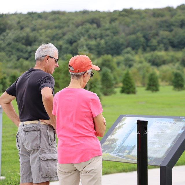 Visitors reading a wayside.