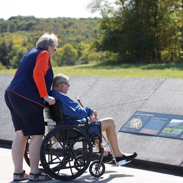 Visitors reading waysides.