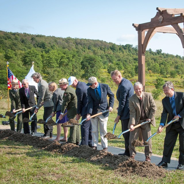 A group of People with shovels.