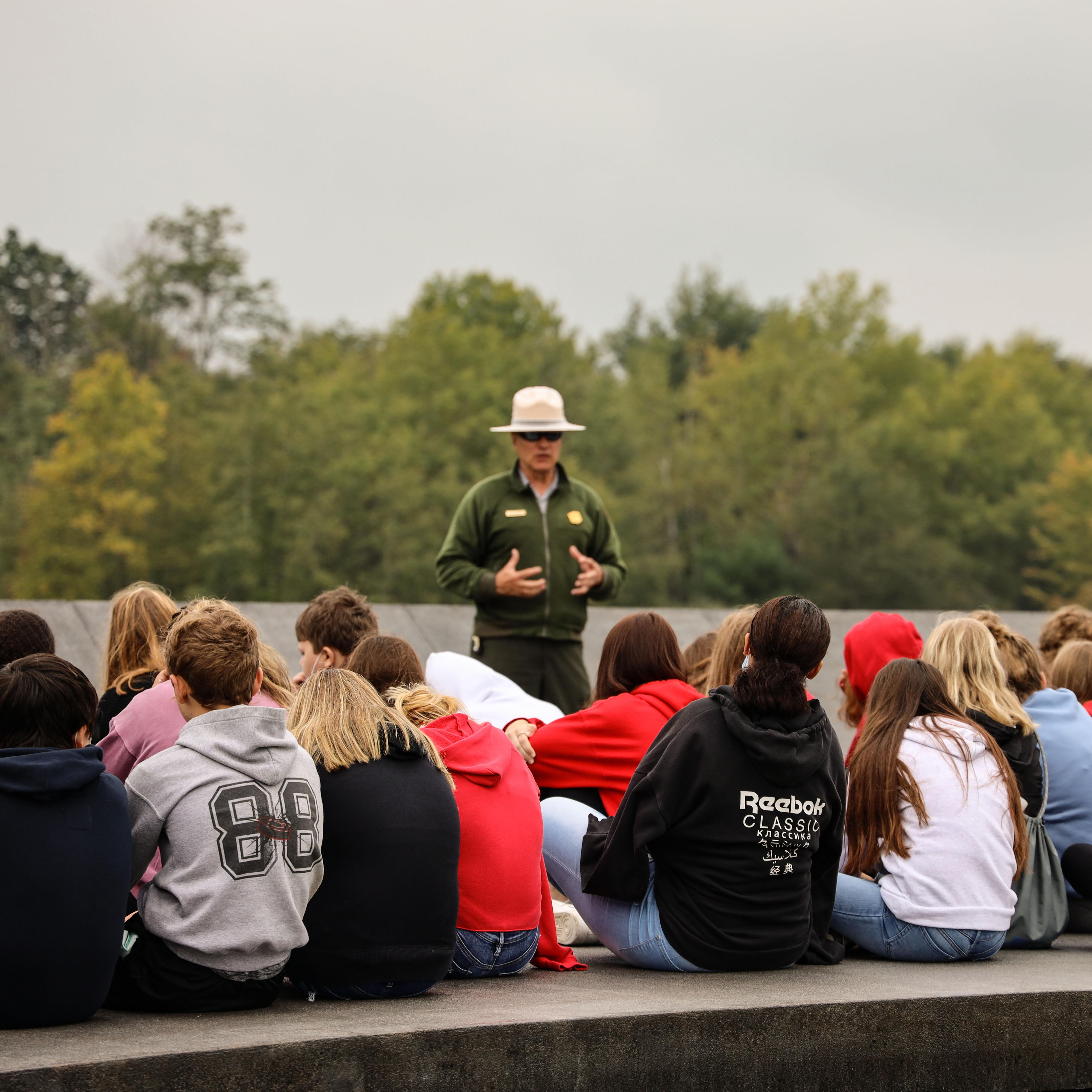 A Park Ranger speaks to a group of students