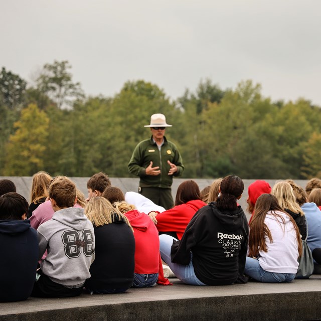 A Park Ranger speaks to a group of students